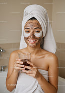 Young Woman Enjoying Facial Mask and Skincare Routine in Bathroom