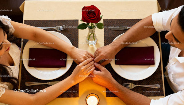 Couple Holding Hands During Romantic Dinner Date