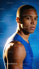 Focused young male athlete in blue sportswear