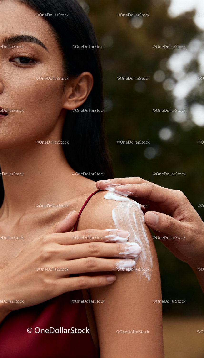 Woman Receiving Gentle Shoulder Moisturizing Care Outdoors