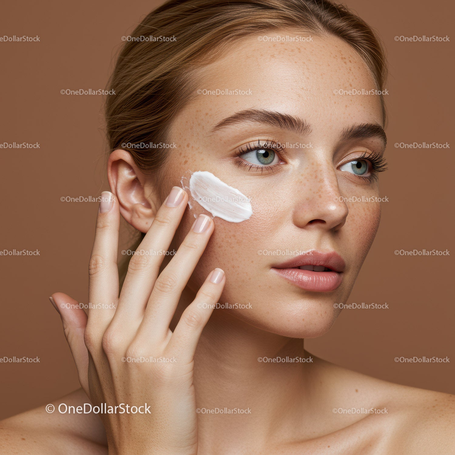 Close-up of a woman applying moisturizer to her face for healthy skin