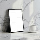 Digital Tablet and Coffee Cup on Marble Surface