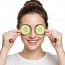 Happy Woman with Cucumber Slices Over Eyes in Skincare Routine