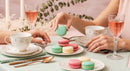 Elegant Tea Party with Colorful Macarons and Fine China in Soft Pastels