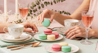 Elegant Tea Party with Colorful Macarons and Fine China in Soft Pastels