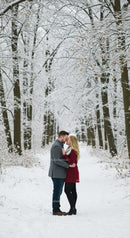 Couple Sharing Intimate Moment in Snowy Winter Forest