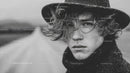 Stylish Man with Curly Hair in Rainy Weather Fashion Portrait