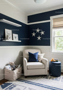 Cute Nursery Room with Navy Blue Accent Wall and Plush Decor