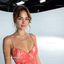 Young Woman Smiling in Summer Pink Dress with Necklace