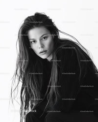 Black and White Portrait of a Woman with Wet Hair and Intense Gaze