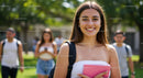 Happy Young Woman Carrying Pink Notebook in Sunny Campus