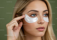 Close-up of Woman with Blue Eyes Applying Eye Mask for Beauty
