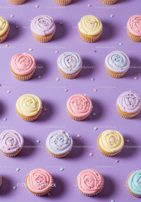 Colorful pastel cupcakes arranged on purple surface