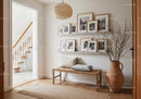 Cozy minimalist hallway with bench and photo frames