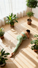 Woman Practicing Yoga Stretch Surrounded by Green Plants