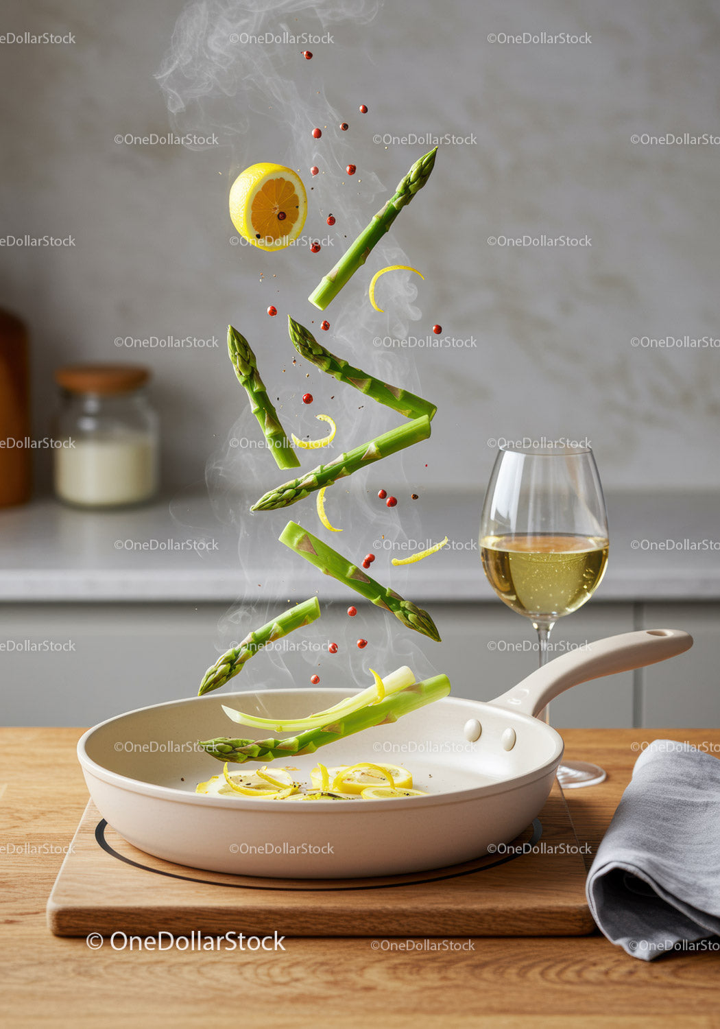 Fresh asparagus and lemon cooking in sizzling pan