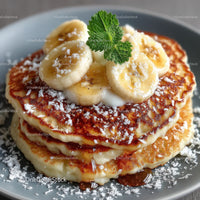 Banana Pancakes with Sliced Bananas and Mint Garnish