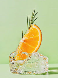 Fresh Orange Slice with Rosemary on Ice Cube