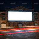 Empty illuminated billboard on old industrial building at night