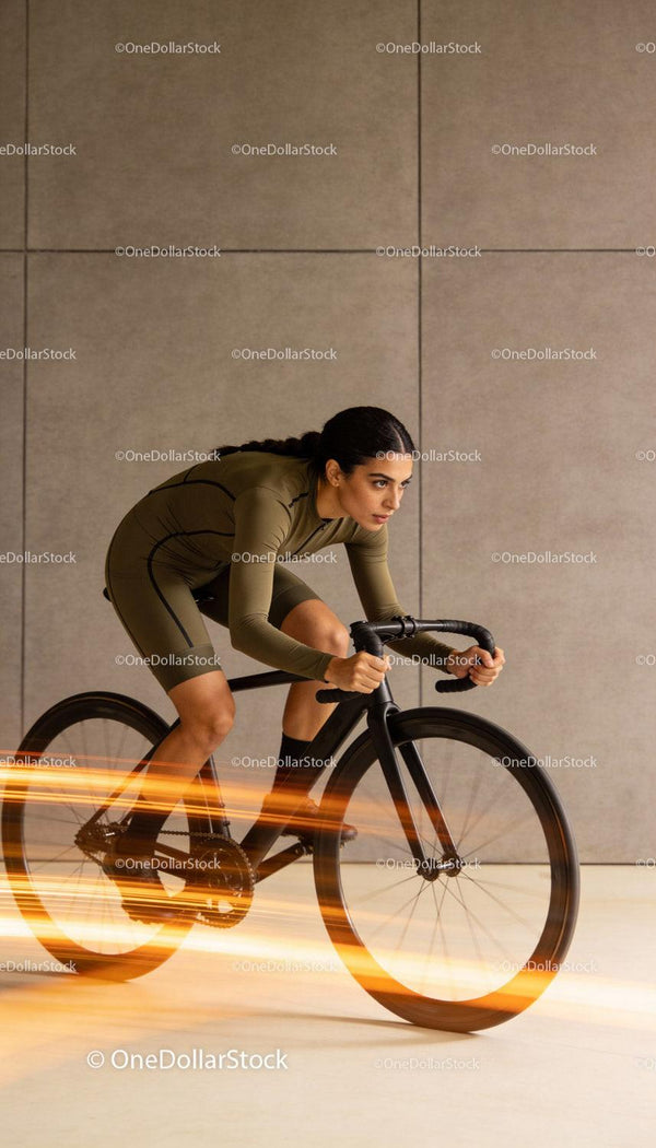 Focused cyclist speeding indoors with motion blur effect