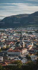 Scenic Cityscape with Church and Mountain Backdrop in Clear Day