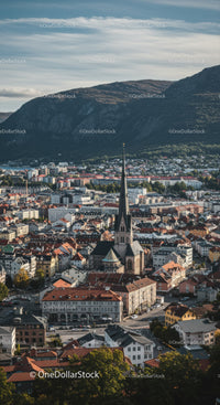 Scenic Cityscape with Church and Mountain Backdrop in Clear Day
