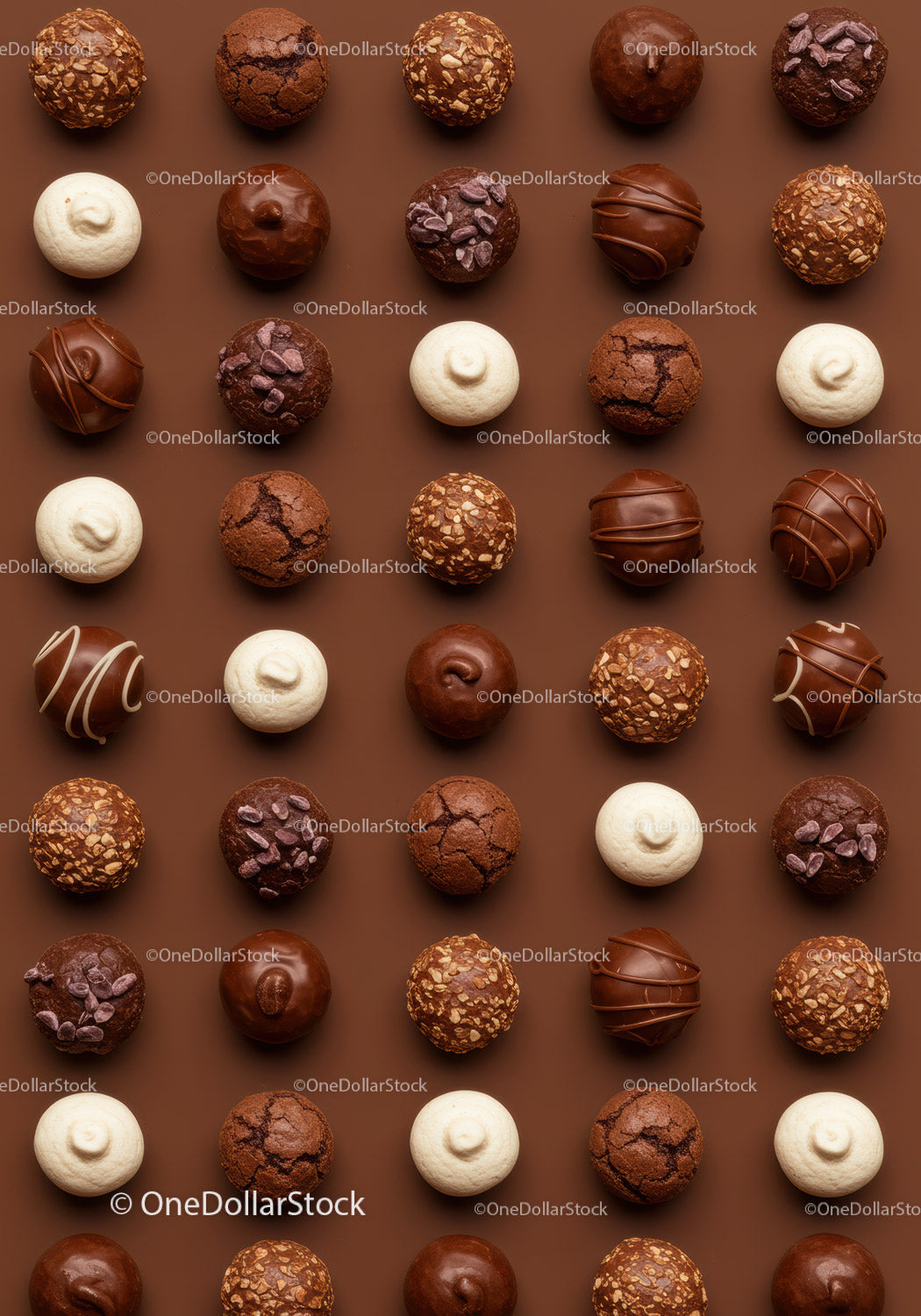 Assorted gourmet chocolate truffles on brown background