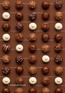 Assorted gourmet chocolate truffles on brown background