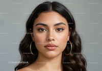 Close-Up Portrait of a Beautiful Young Woman with Brown Hair and Earrings