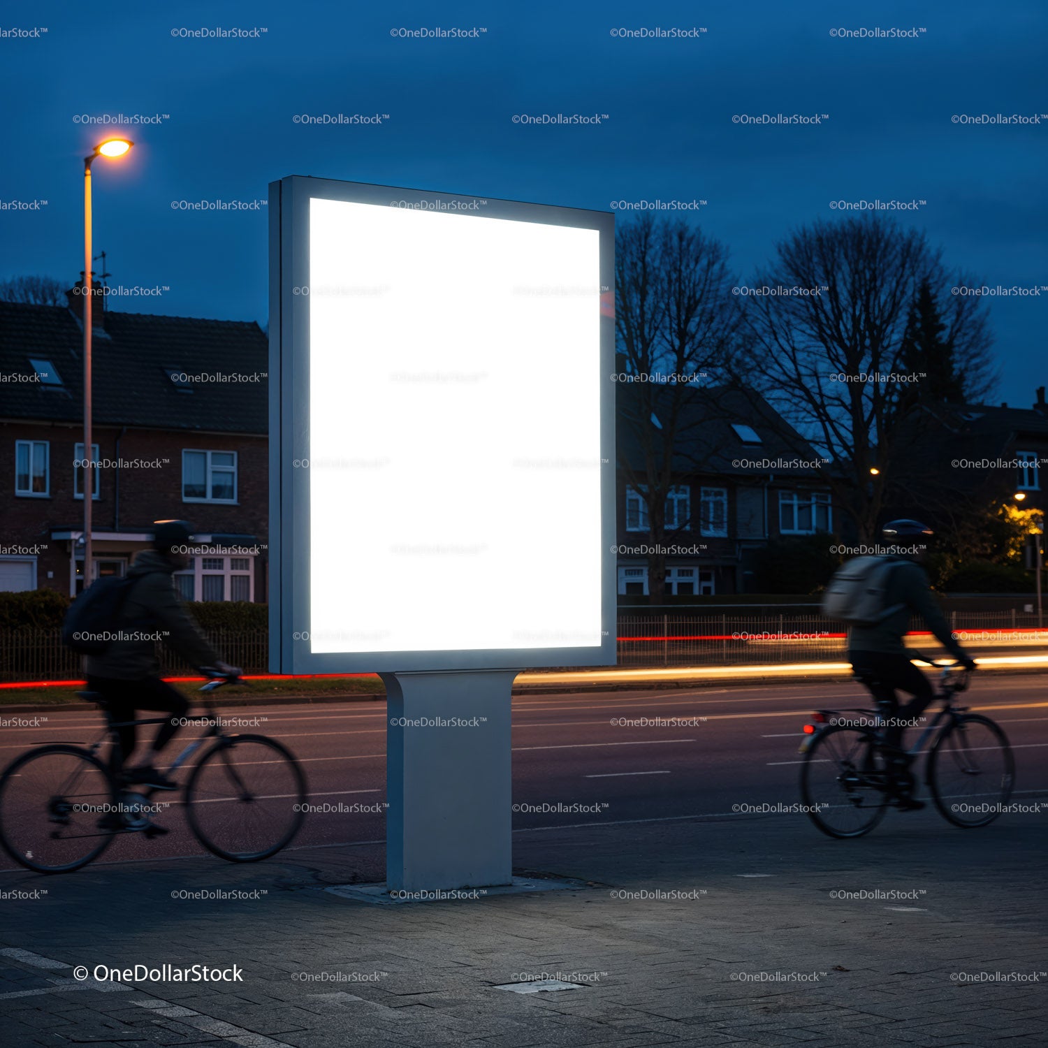 Empty Illuminated Billboard by Road with Cyclists at Dusk
