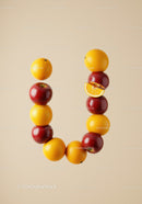 Creative U shaped letter made of apples and oranges