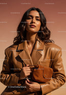 Elegant Woman in Leather Jacket with Brown Bag in Studio Lighting