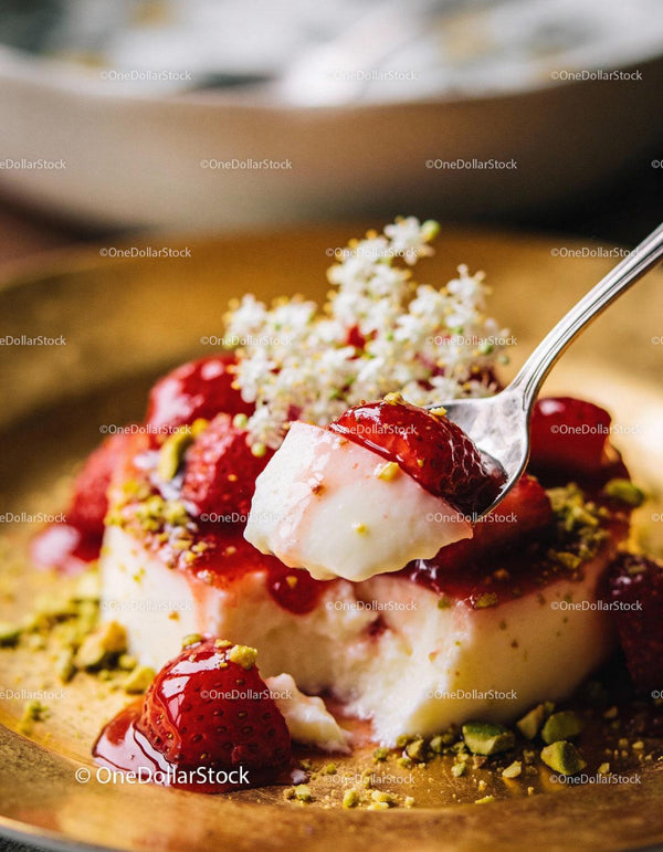 Creamy dessert with fresh strawberries and crushed pistachios