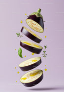 Sliced eggplant with olive oil and fresh herbs floating