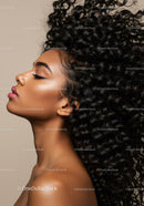 Portrait of serene woman with voluminous curly hair