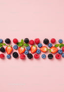 Fresh mixed berries with mint leaves on pink background