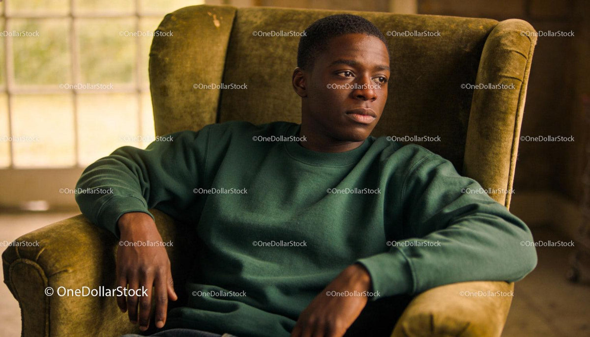 Thoughtful young man resting in vintage armchair
