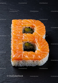 Creative salmon sushi roll shaped as letter B