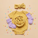 Yellow Baby Onesie with Lilac Socks and Headband Flatlay
