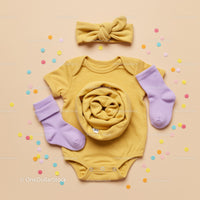 Yellow Baby Onesie with Lilac Socks and Headband Flatlay