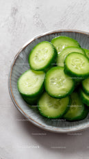 Fresh Cucumber Slices in a White Bowl for Healthy Snacking