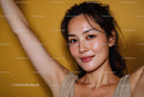Young Woman with Freckles Smiling Portrait on Yellow Background