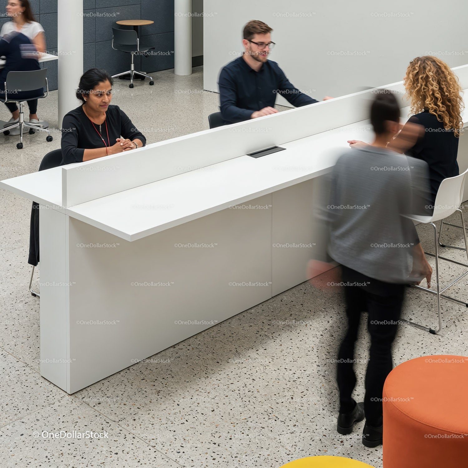 People interacting at modern communal workspace counter