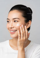 Young Woman Applying Skincare Cream for Glowing Healthy Skin