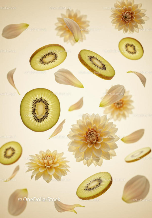 Sliced green kiwis with soft yellow dahlia petals floating