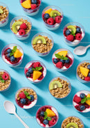 Colorful yogurt parfaits with fresh fruit and granola
