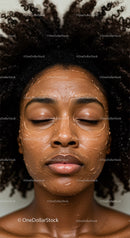 African American Woman Relaxing with Facial Mask and Curly Hair