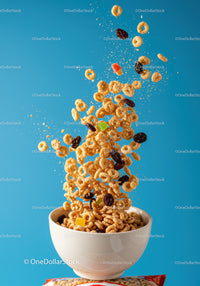Flying cereal rings with dried fruits over bowl