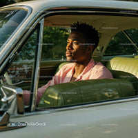 Young Man in Pink Shirt Sitting in Vintage Car on a Sunny Day
