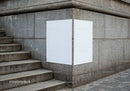 Blank posters on corner stone wall near urban stairs